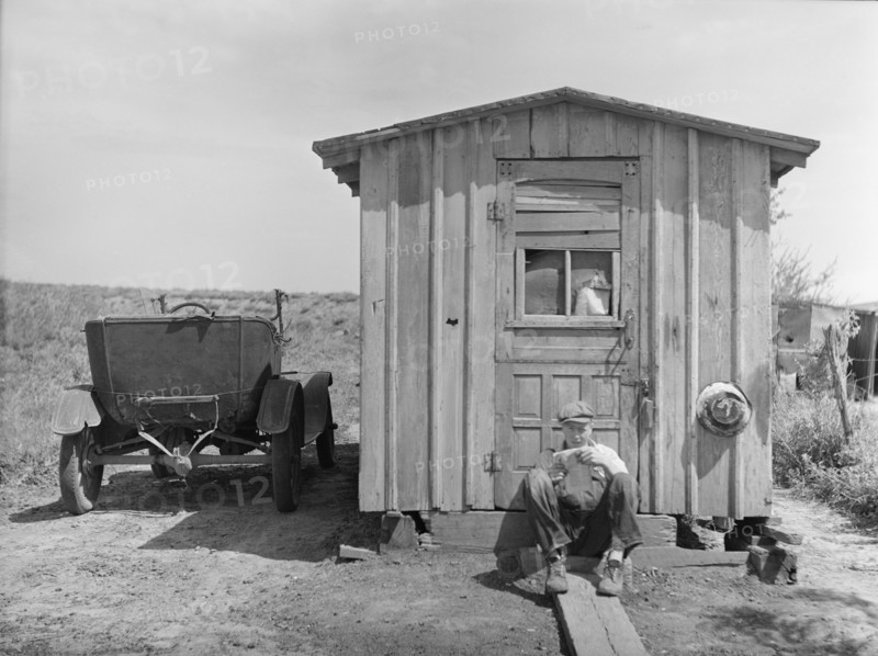 Worker in Strip Coal Mine Sitting in front of Home, Cherokee County, Kansas, USA, Arthur Rothstein, Farm Security Administration, May 1936