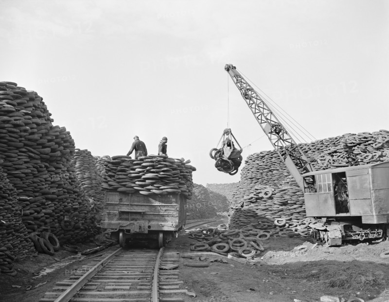 Workers Stacking Discarded Tire Casings at Recovery Plant with the Reclaimed Material to be Manufactured into Thousands of Essential Mechanical Rubber Products, Firestone Tire and Rubber Company, Akron, Ohio, USA, Alfred T. Palmer for Office of War Information, December 1942