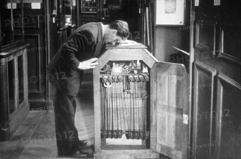Man Looking into a Kinetoscope, Invented by Thomas A. Edison in 1889
