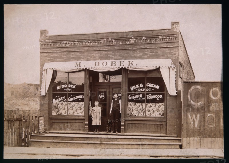 Girl, Dog and Man in Front of Store, 1900
