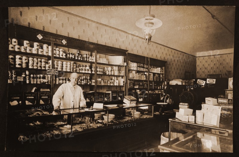 Man Standing Behind Counter in Grocery Store, Chicago, Illinois, USA, 1914