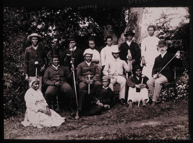 Group of Zulu Men and Women in Western Clothes With a British Gentleman, South Africa, circa 1890