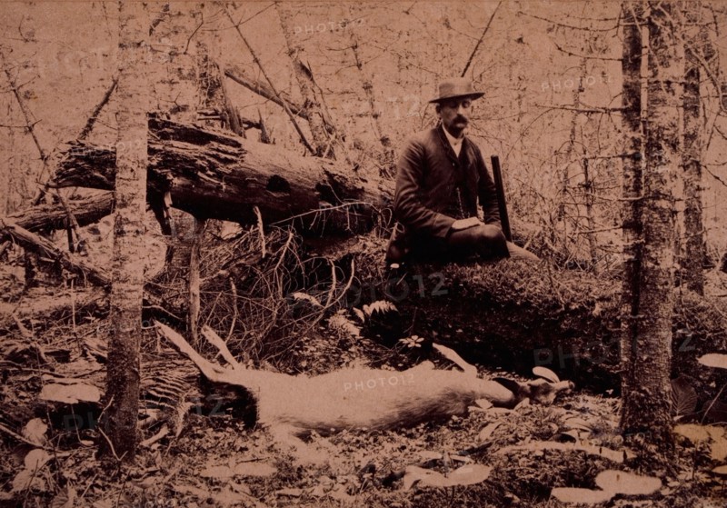 Hunter Seated on Log Next to Dead Animal, circa 1890
