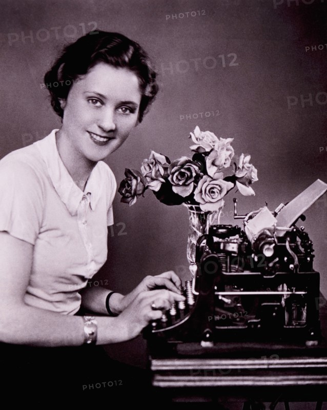 Smiling Woman Typing on Typewriter, circa 1930's