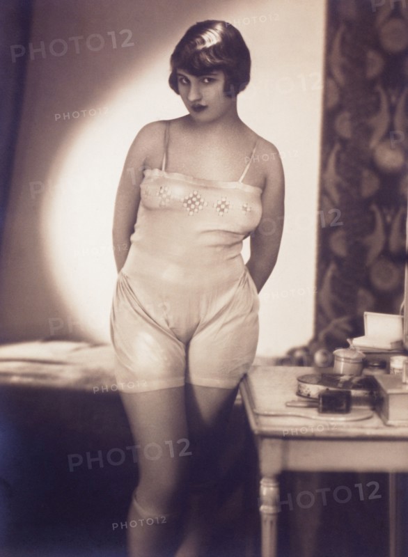 French Lingerie Model Standing Next to Bed, 1915
