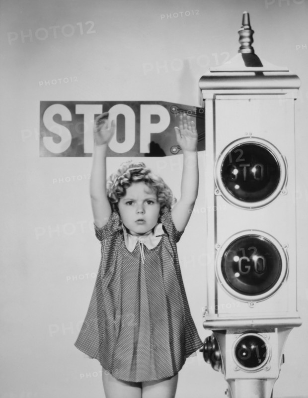 Shirley Temple, Holding Hands Up Against Stop Sign, Portrait, 1934