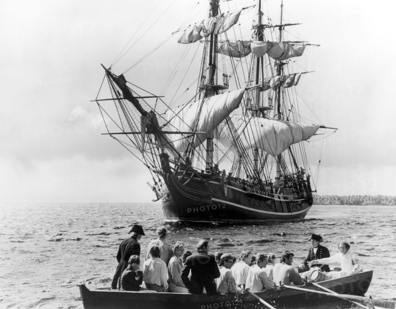 Trevor Howard and Crew Adrift in Longboat with HMS Bounty in Background, on-set of the Film, "Mutiny on the Bounty" directed by Lewis Milestone, 1962