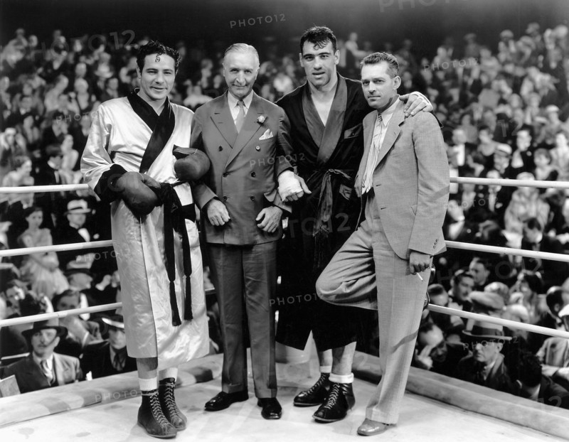 Max Baer (left), Primo Carnera (second from right), director W.S. Van Dyke (right) on-set of the Film, "The Prizefighter and the Lady", 1933