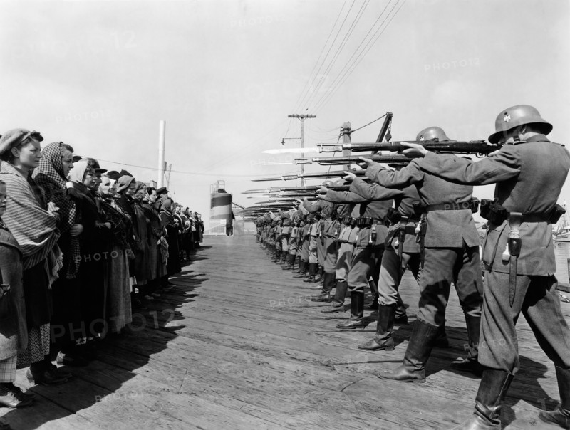 Row of German Soldiers with Rifles and Bayonets aimed at Norwegian Prisoners, on-set of the Film, "Edge of Darkness", 1943