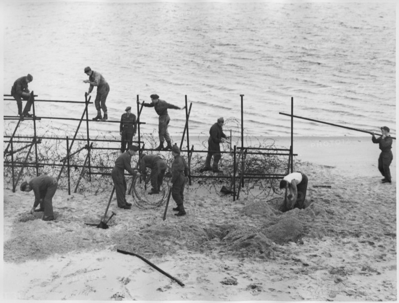 WWII Soldiers Constructing Barricade on Beach, from the British Documentary Film, "A Diary for Timothy", 1945
