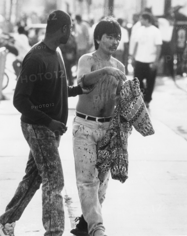 Bloodied Man Being Escorted to Safety During Riots Resulting from Rodney King's Verdict, Los Angeles, California, USA, 1992