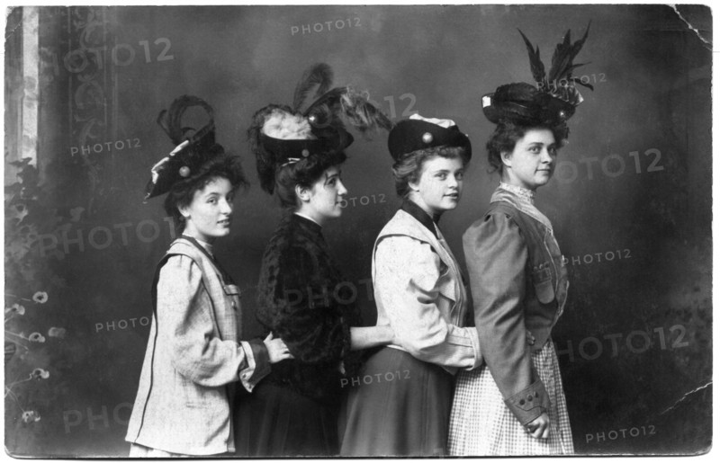 Four Fashionable Women in Feathered Hats Standing in Row with Hands Touching Waists, Portrait, circa 1915