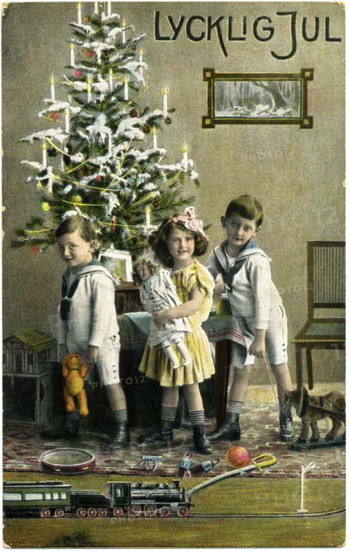 Three Children with Presents and Train Set in Front of Christmas Tree, "Lycklig Jul", Postcard, Sweden, circa 1912