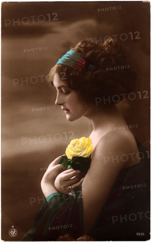 Woman in Green Dress and Headband Holding Yellow Rose against Chest, Profile, Hand-Colored Postcard. Circa 1920's