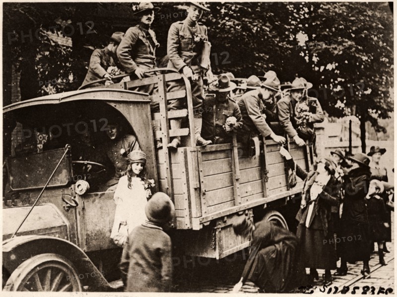 French Women giving Flowers to American Soldiers Heading to the Front, Paris, France, circa 1918