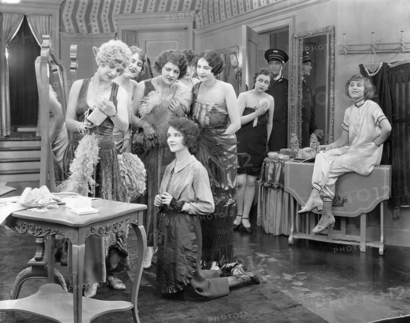 Mary Philbin, (kneeling), on-set of the Silent Film, "Fifth Avenue Models", 1925