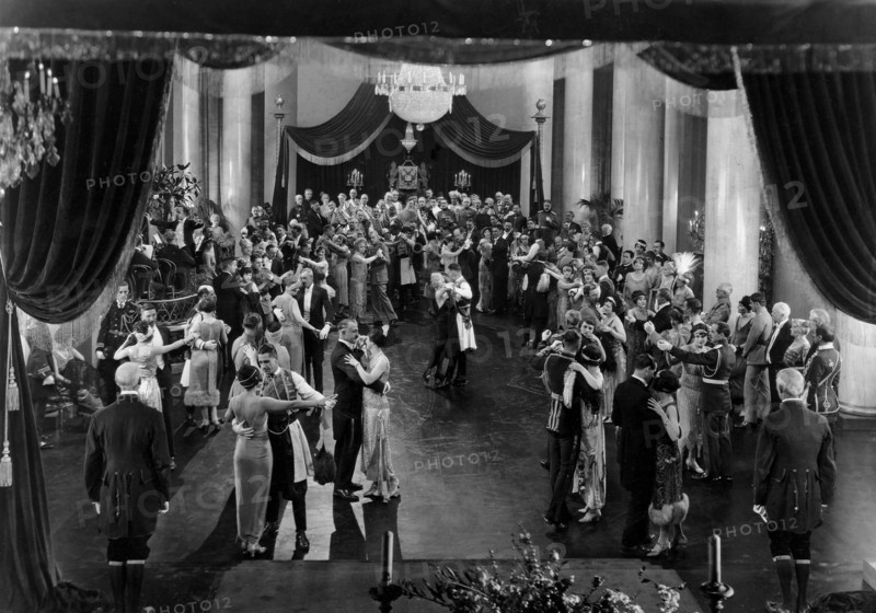 Mae Murray, John Gilbert, (center), Clark Gable, (as an extra, below right-hand canopy post), on-set of the silent film, "The Merry Widow", 1925