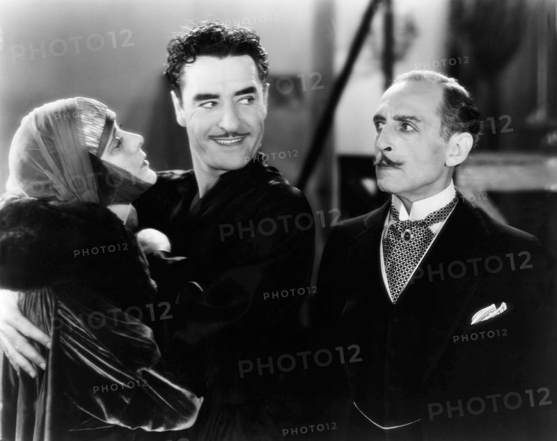 Alma Rubens, John Gilbert, Frank Reicher, on-set of the Silent Film "The Masks of the Devil", 1928