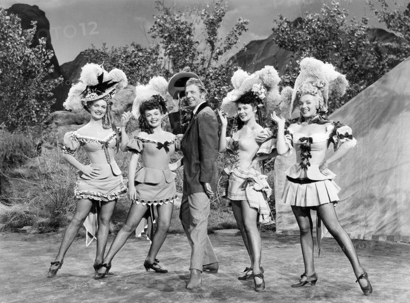 Dan Dailey, with Chorus Girls Marion Marshall, Joyce Mackenzie, Barbara Smith, Marilyn Monroe, on-set of the Film "A Ticket to Tomahawk", 1950