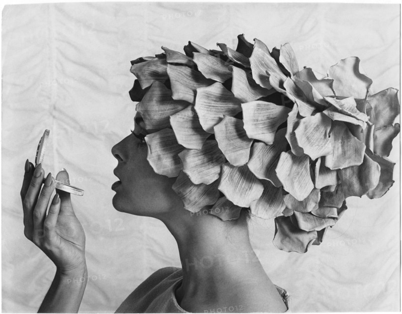 Profile of Woman in Petal Hat Looking at Compact Mirror, 1965