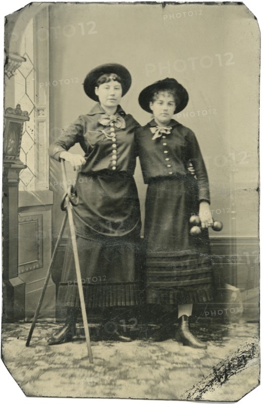 Portrait of Two Young Adult Women, Both Standing in Hats and Long Skirts with Poles, Rings and  Weights, circa 1870