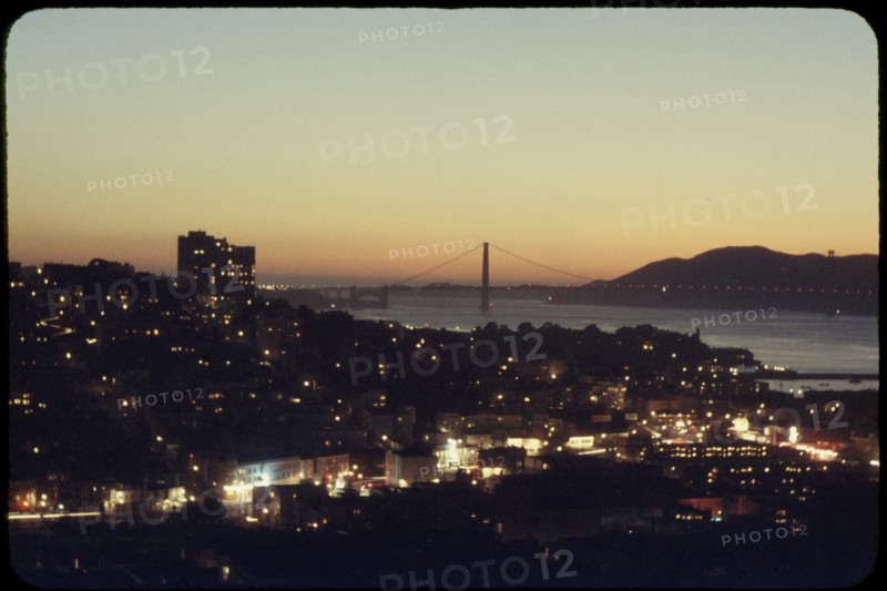 Illuminated Cityscape with Golden Gate Bridge in Background at Sunset, San Francisco, California, USA, 1957