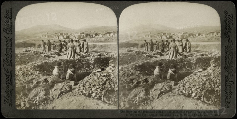 Burying the Russians killed in the desperate fighting on 203 Metre Hill in Besieged Port Arthur, Stereo Card, Underwood & Underwood, 1905