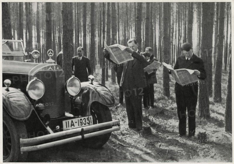 Adolf Hitler and Entourage Standing Alongside his Mercedes while Reading Newspapers in the Woods, Germany, early 1930's