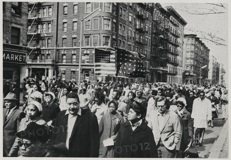 Crowd of Mourners, some Carrying Flags, Marching down 7th Avenue near 112th Street on way to Attend Memorial Service for Dr. Martin Luther King Jr. in Central Park, New York City, New York, USA, April 7, 1968
