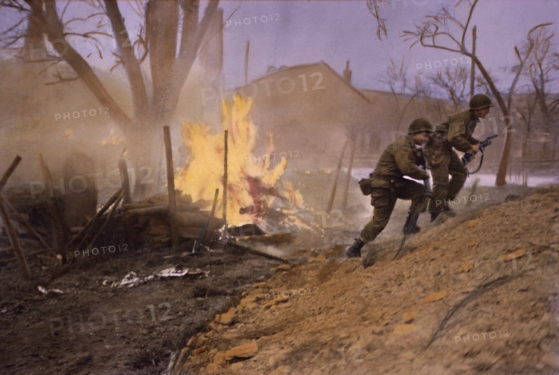 Infantrymen Moving Past Fire Started by Enemy Shelling, Rhineland Campaign, Germany, 1945