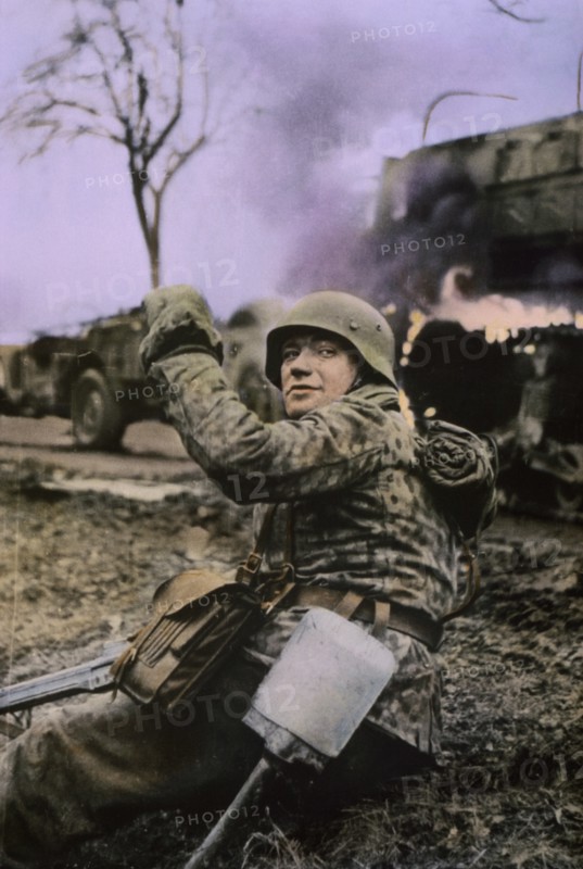 German Soldier Waving Members of his Unit Forward, Ardennes-Alsace Campaign, Battle of the Bulge, 1945