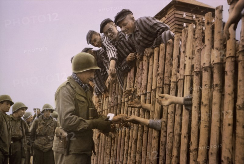 Enlisted Man of Seventh US Army Giving Cigarettes to Liberated Prisoners, Dachau, Germany, Central Europe Campaign, Western Allied Invasion of Germany, April 29,1945