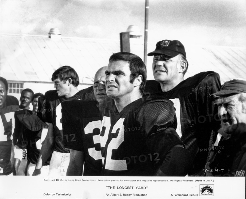 Actor Burt Reynolds, (center), on-set of the Film, "The Longest Yard", Paramount Pictures, 1974