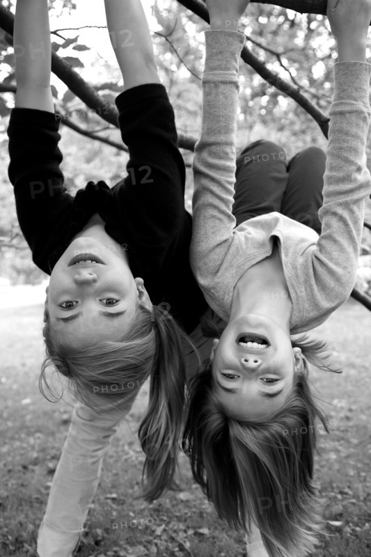 Two Girls Hanging Upside Down