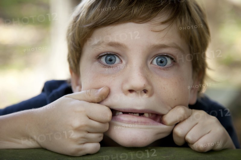 Young Boy Making Funny Face, Close-Up