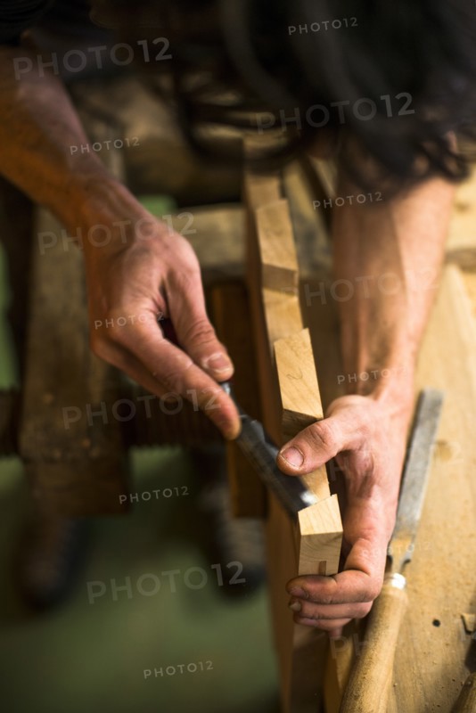 Woodworker Using Chisel on Piece of Wood, High Angle View