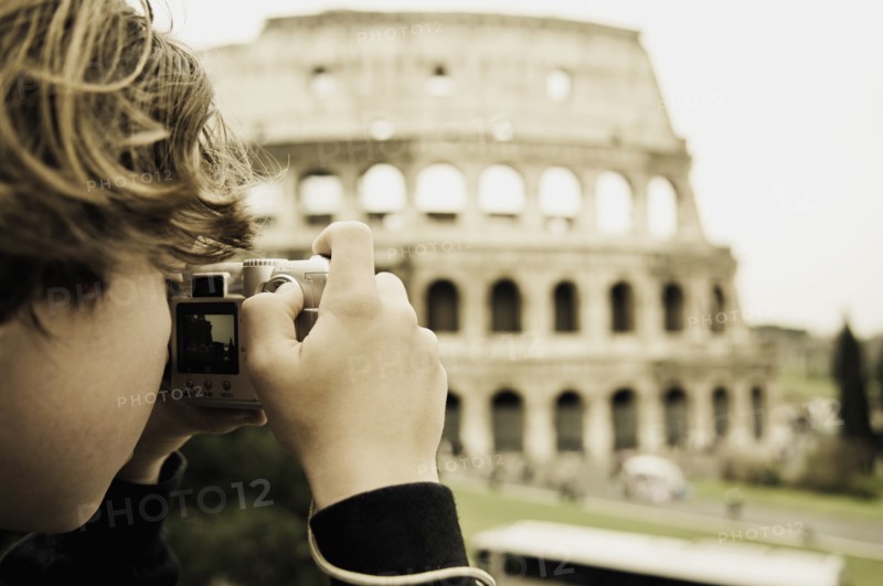 Young Boy Taking Photo of Colosseum, Rome, Italy