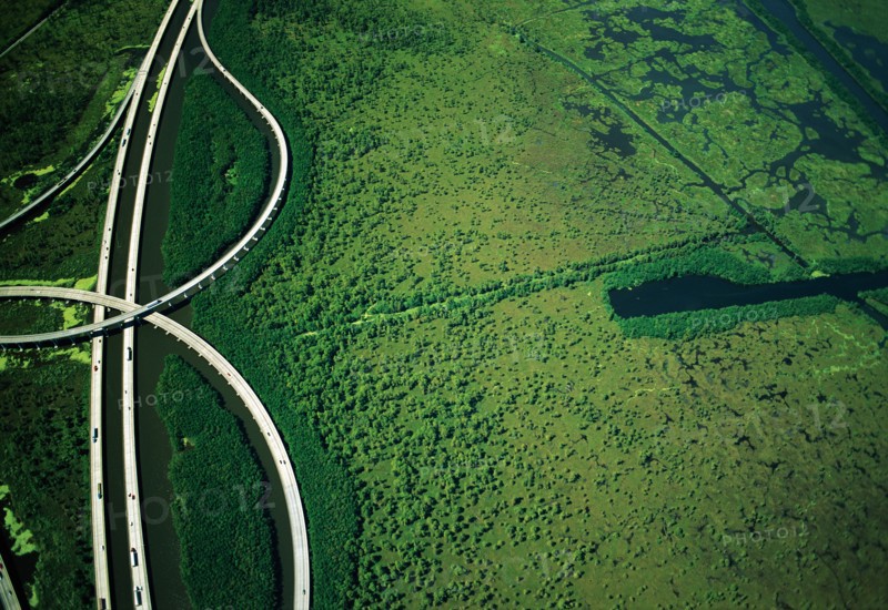 Intersecting Highways near Green Wetlands, High Angle View