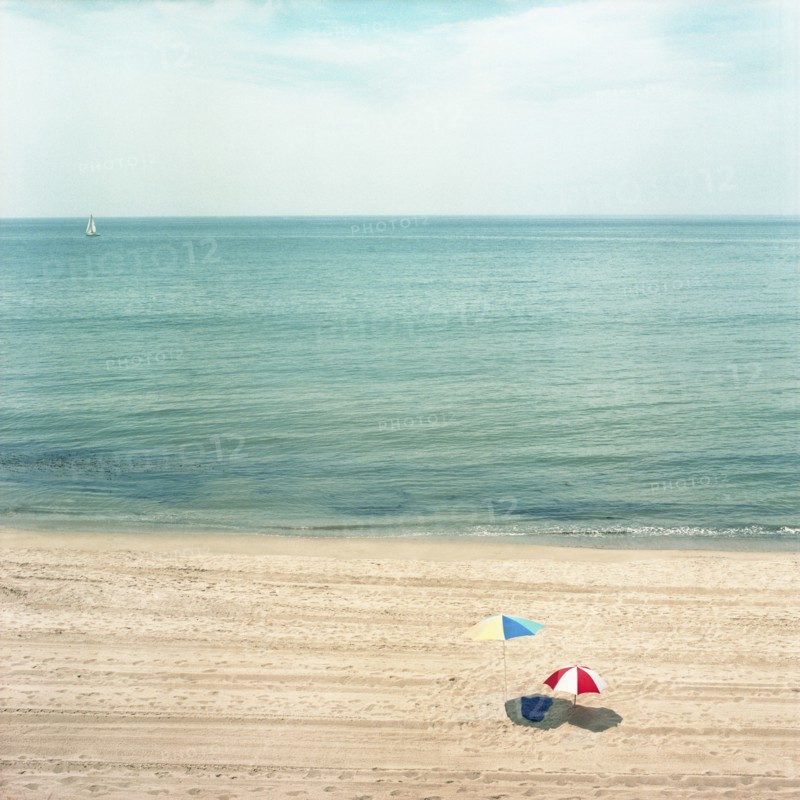 Two Umbrellas on Sandy Beach with Ocean in Background, High Angle View, Los Angeles, California, USA