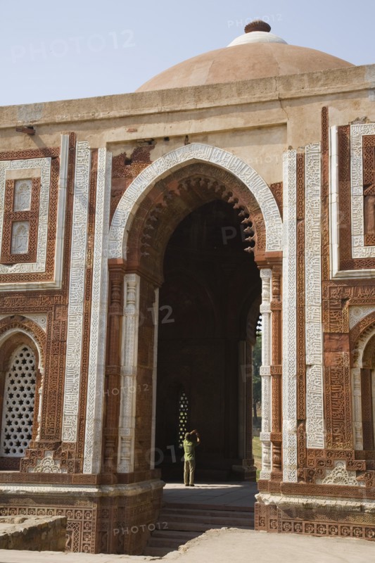 Man Taking Picture in Archway of Tall Mosque, New Delhi, India