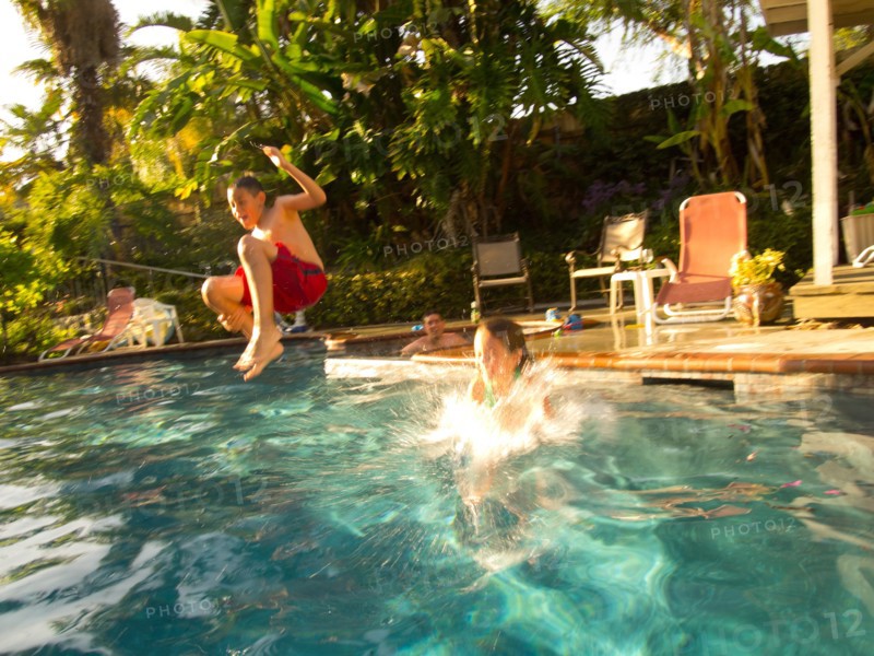 Boy Jumping in Pool