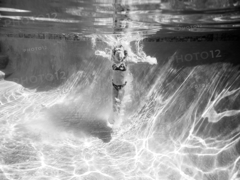 Girl Underwater after Jumping in Pool