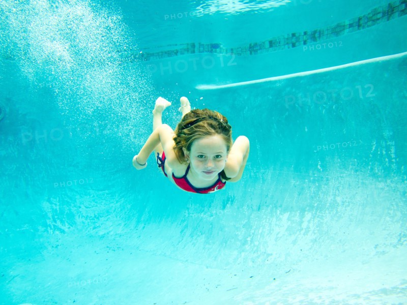 Girl Swimming Underwater in Pool, Eye Contact
