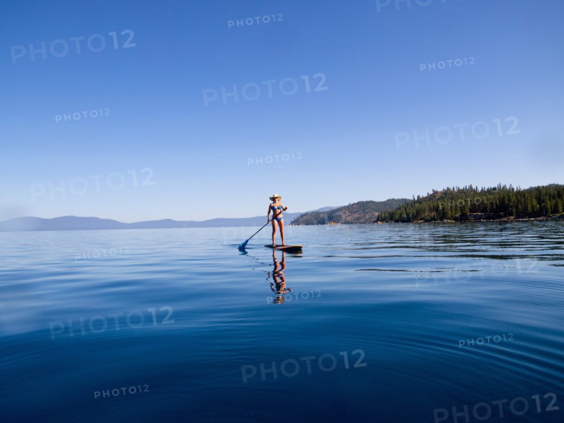 Woman Paddling on Lake