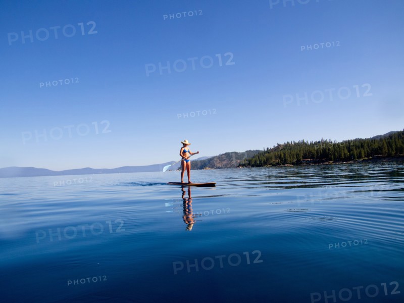 Woman on Paddleboard on Lake