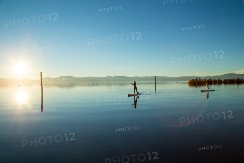 Mother and Daughter on Paddle Boards on Calm Water, Lake Tahoe, Nevada, USA