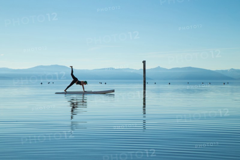 Woman in Yoga Pose on Paddle Board on Lake, Lake Tahoe, Nevada, USA