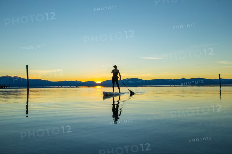 Woman on Paddle Board at Sunset, Lake Tahoe, Nevada, USA