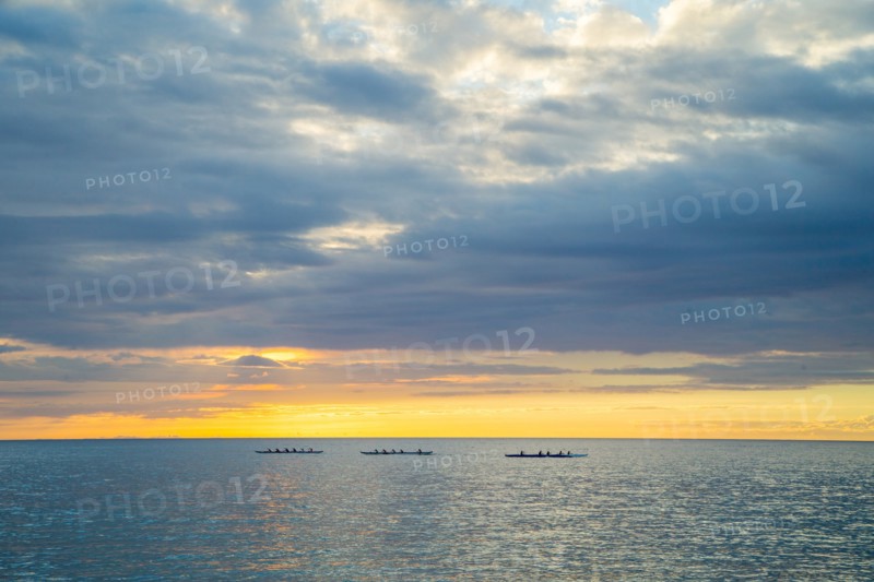 Three Outrigger Canoe Clubs Paddling at Sunset, Hawaii, USA