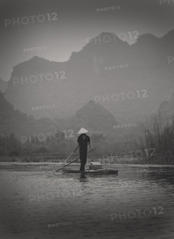 Fisherman Standing on Small Boat, Vietnam